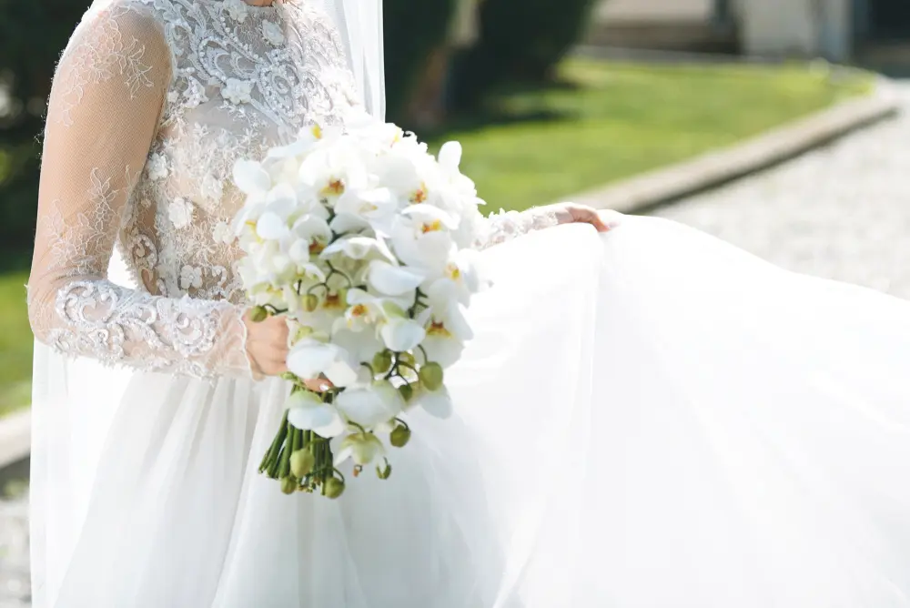 A bride in a wedding dress holding a bouquet of flowers.